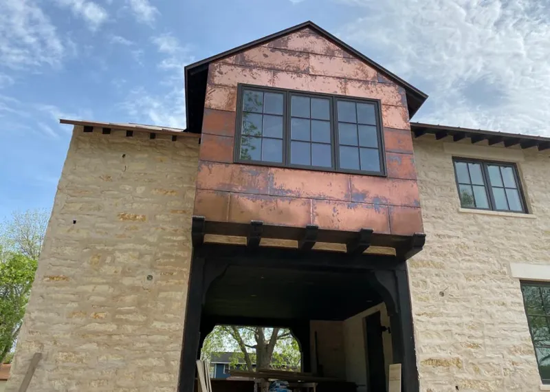 Copper metal panel facade on a stone building for Skylight Installation in Lower Burrell